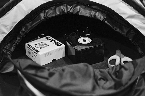 Black and white film photo of my changing back with bulk loading gear