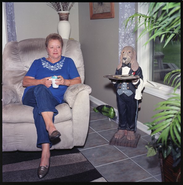 My mom in her chair next to the dog butler