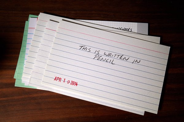 Index card with "This is written in pencil", written in pencil