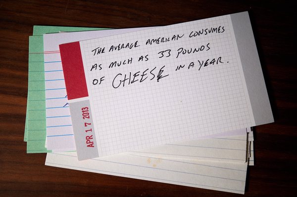 Index card reading "The average American consumes as much as 33 pounds of cheese in a year"