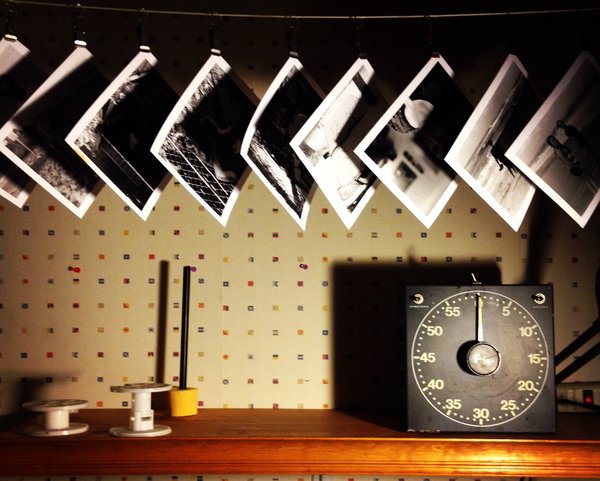 My old darkroom shelf with prints hanging to dry above it.